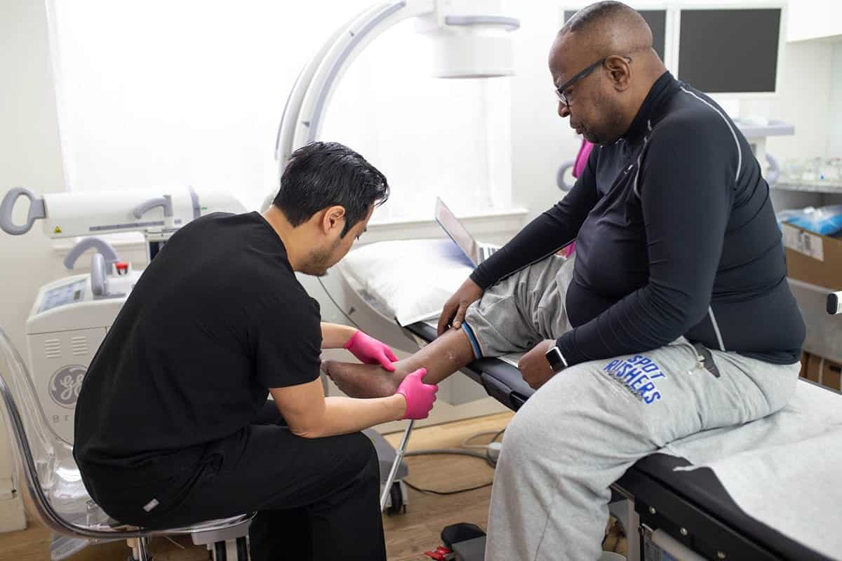 Dr.-Michael-Nguyen-examining-a-patient Vein Specialist in NYC