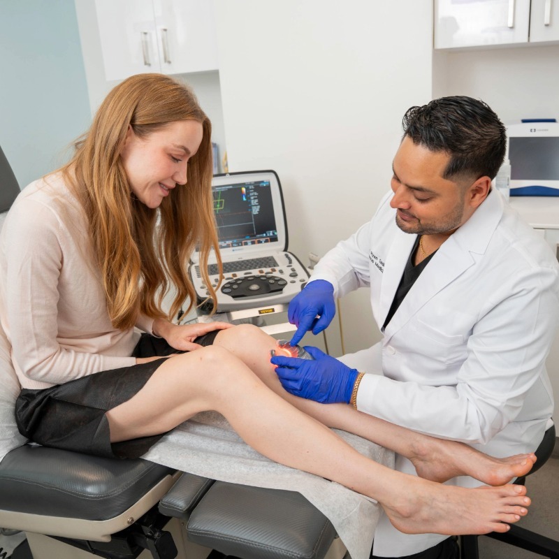 Dr. Shaun Cole performing a leg ultrasound evaluation on a patient at Vein Centers NY in Astoria, New York.